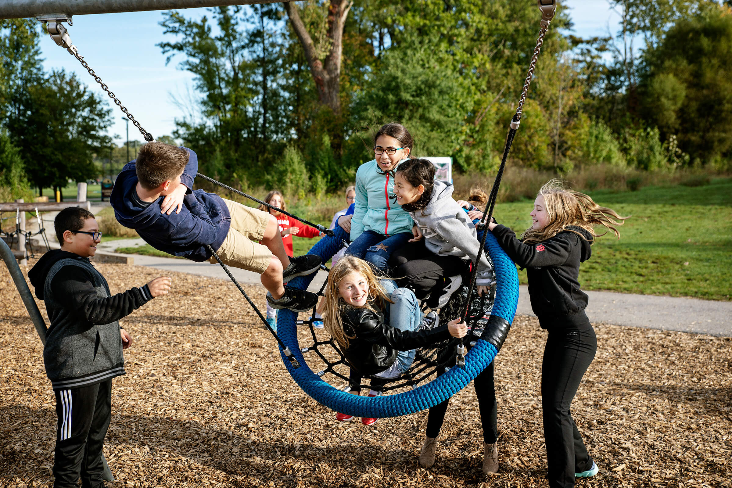 4 children on the birds nest swing at Riverside Intermediate School 