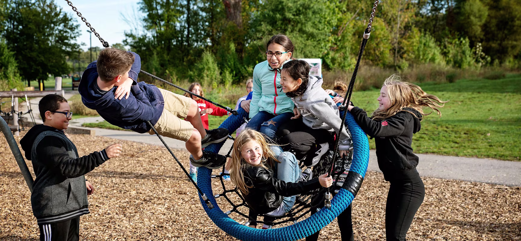 4 children on the birds nest swing at Riverside Intermediate School