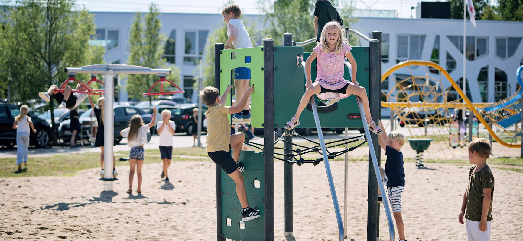 Children climbing on playground climbing structures at KOMPAN Denmark