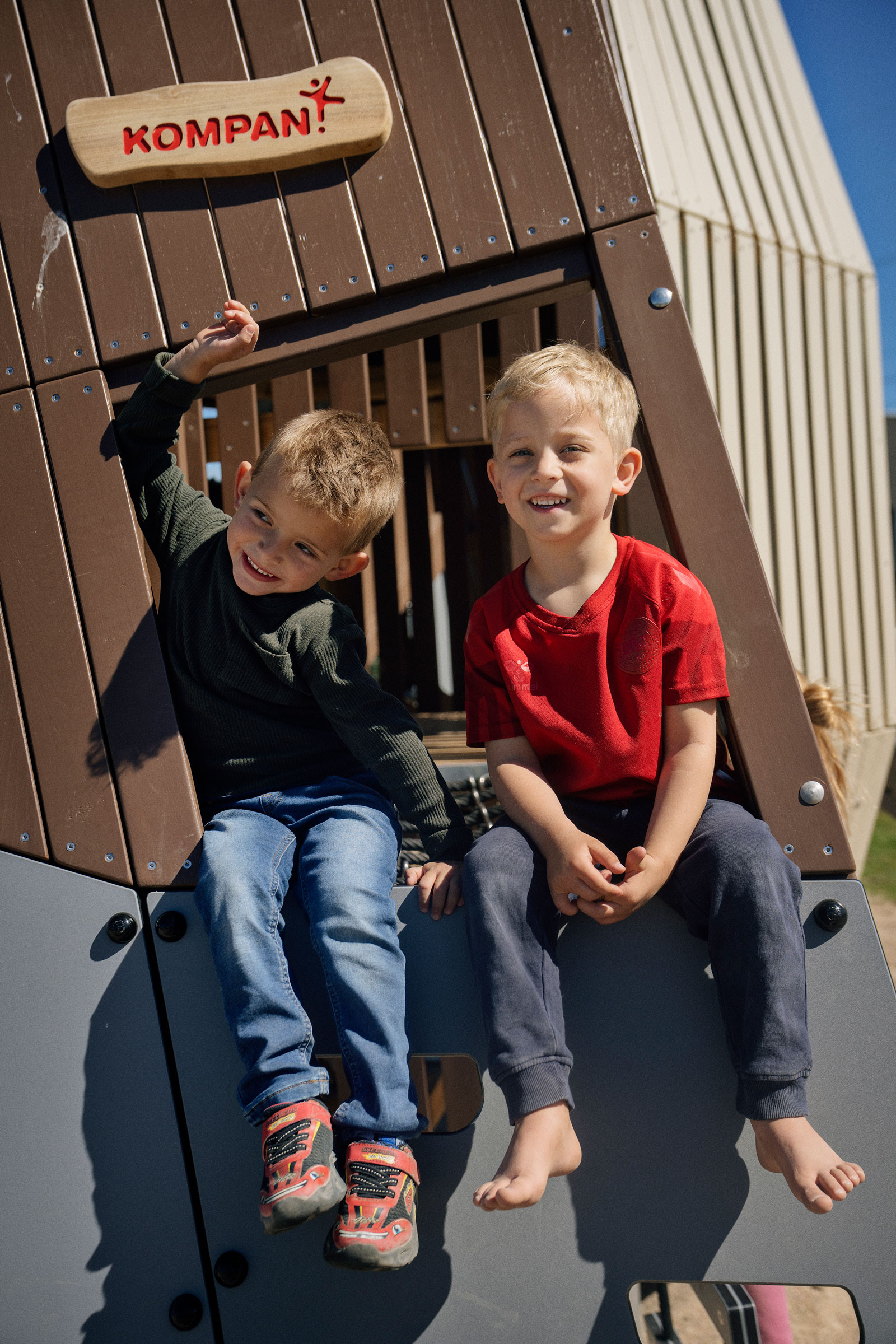 boys playing together on a playground sculpture