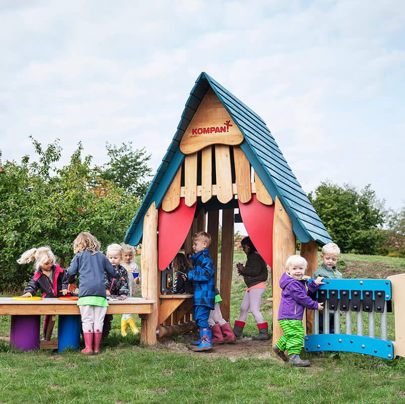 Multiple young children playing within a playground structure for preschoolers.