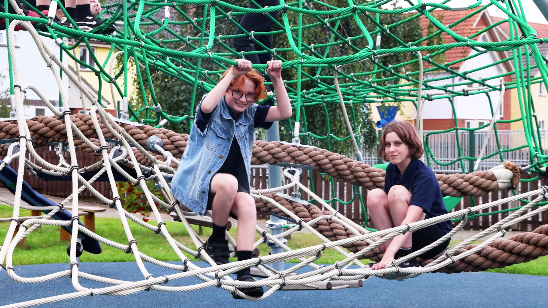 Children playing on playground climbing dome