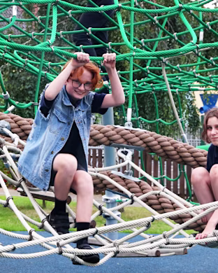 Children playing on playground climbing dome