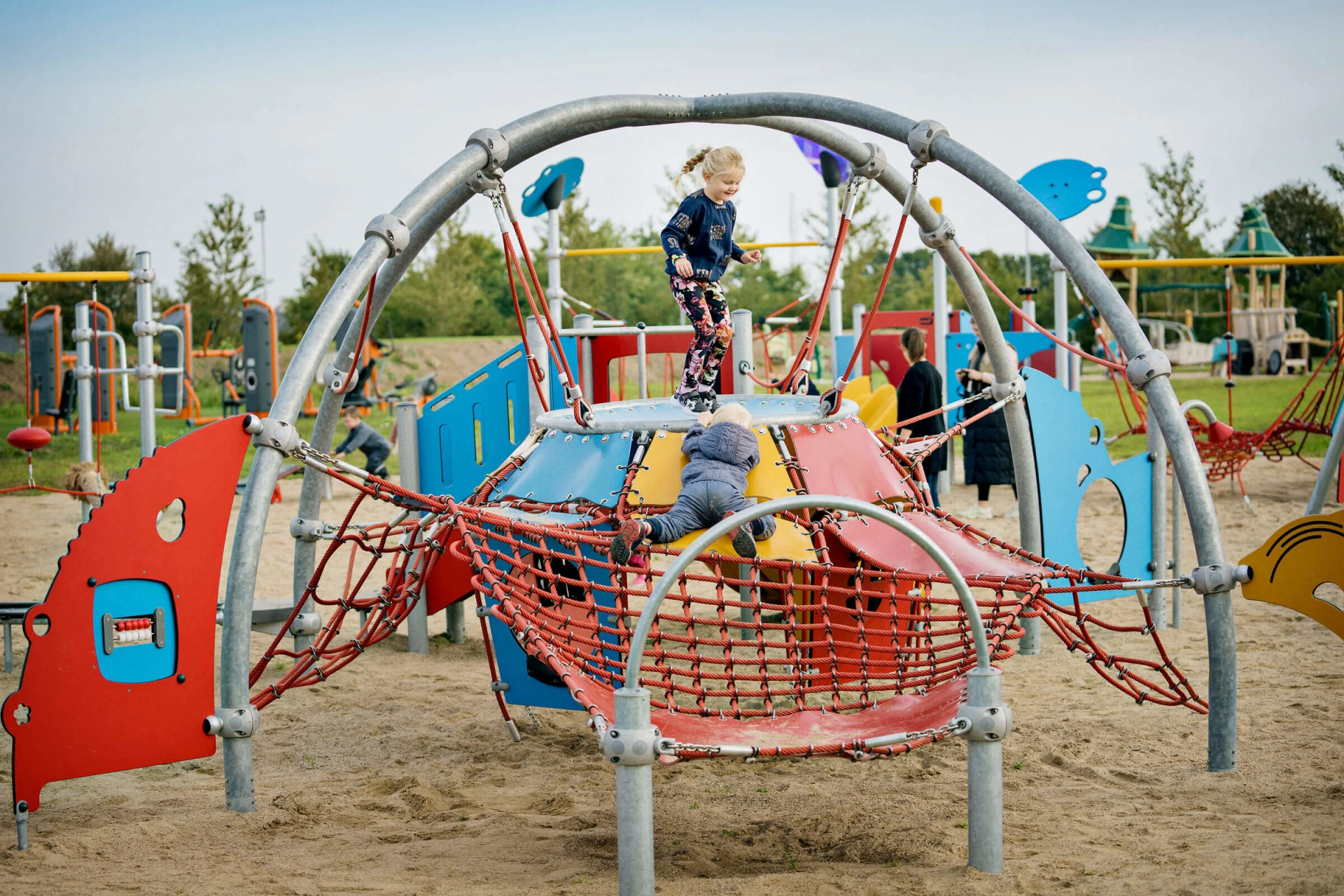 Children playing on playground climbing dome