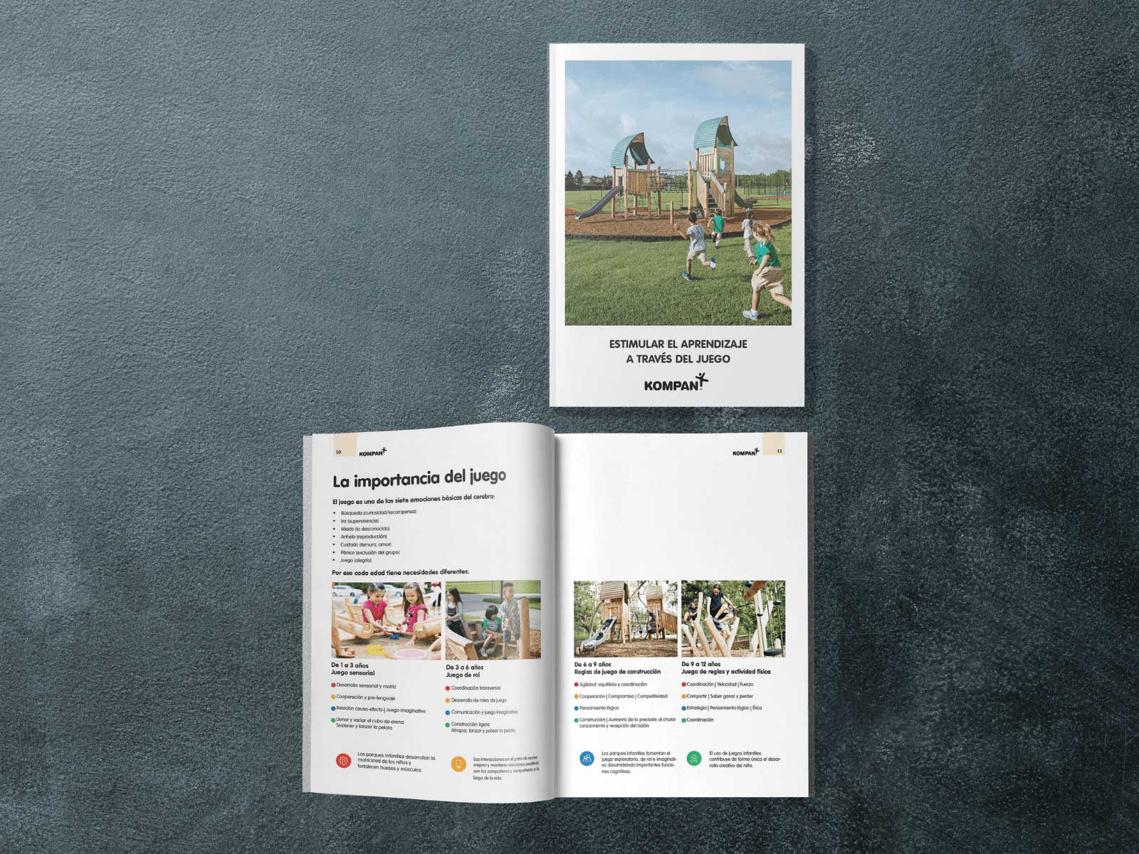Two brochures on a dark surface, one closed showing kids playing on a playground, one open with Spanish text and photos of children.