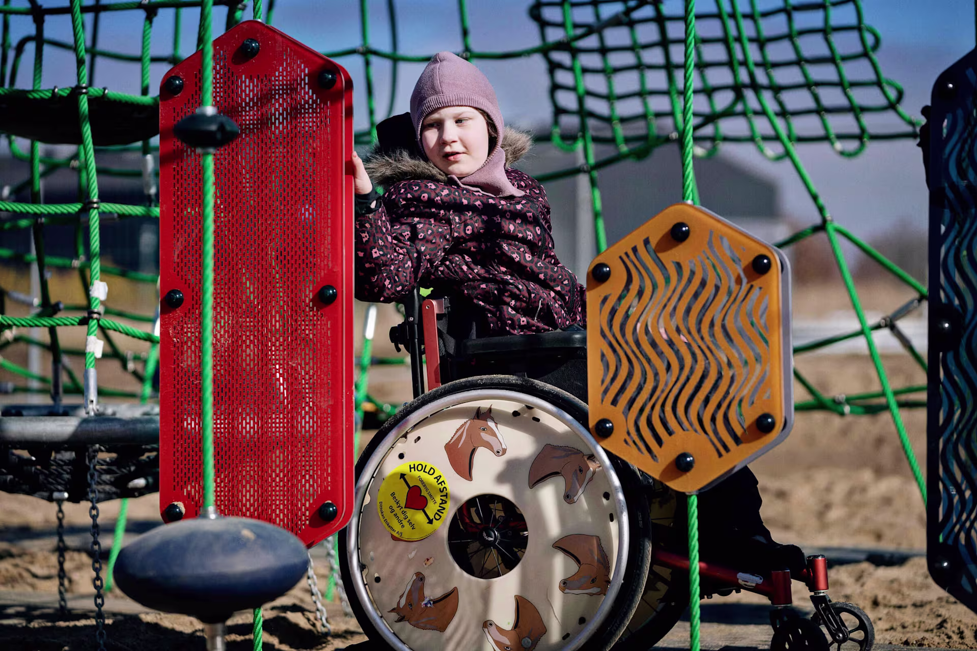 girl in wheelchair playing with sensory play plates 