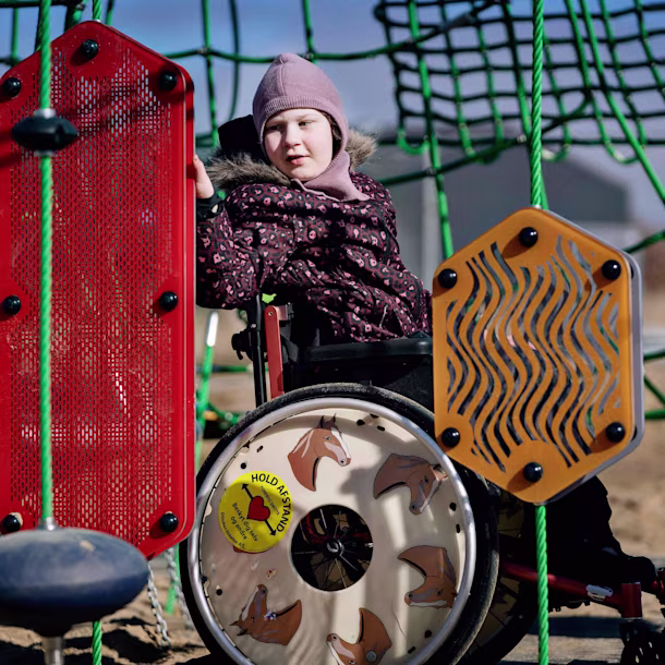 girl in wheelchair playing with sensory play plates