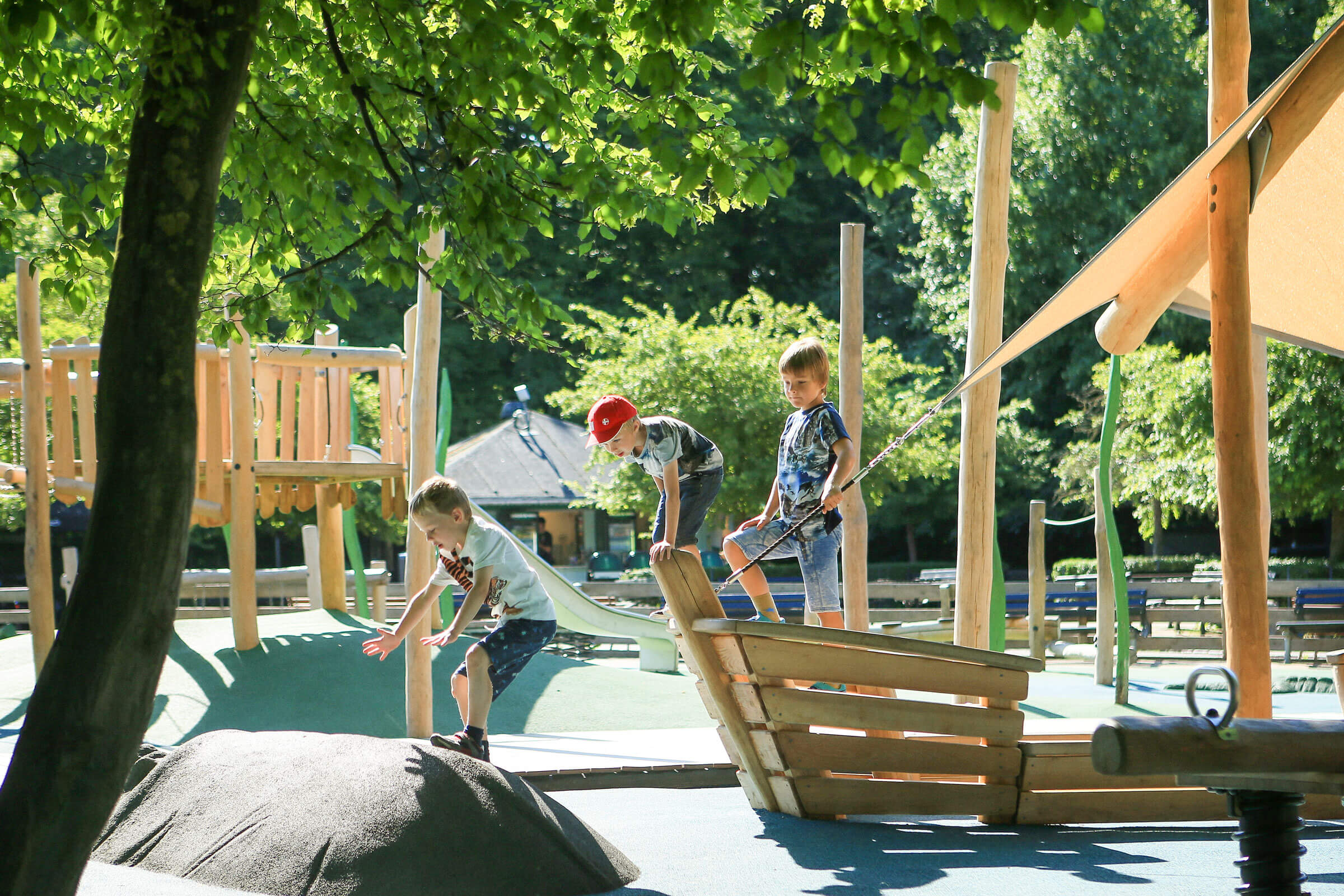 Boy jumping from a wooden boat on playground in Copenhagen Zoo