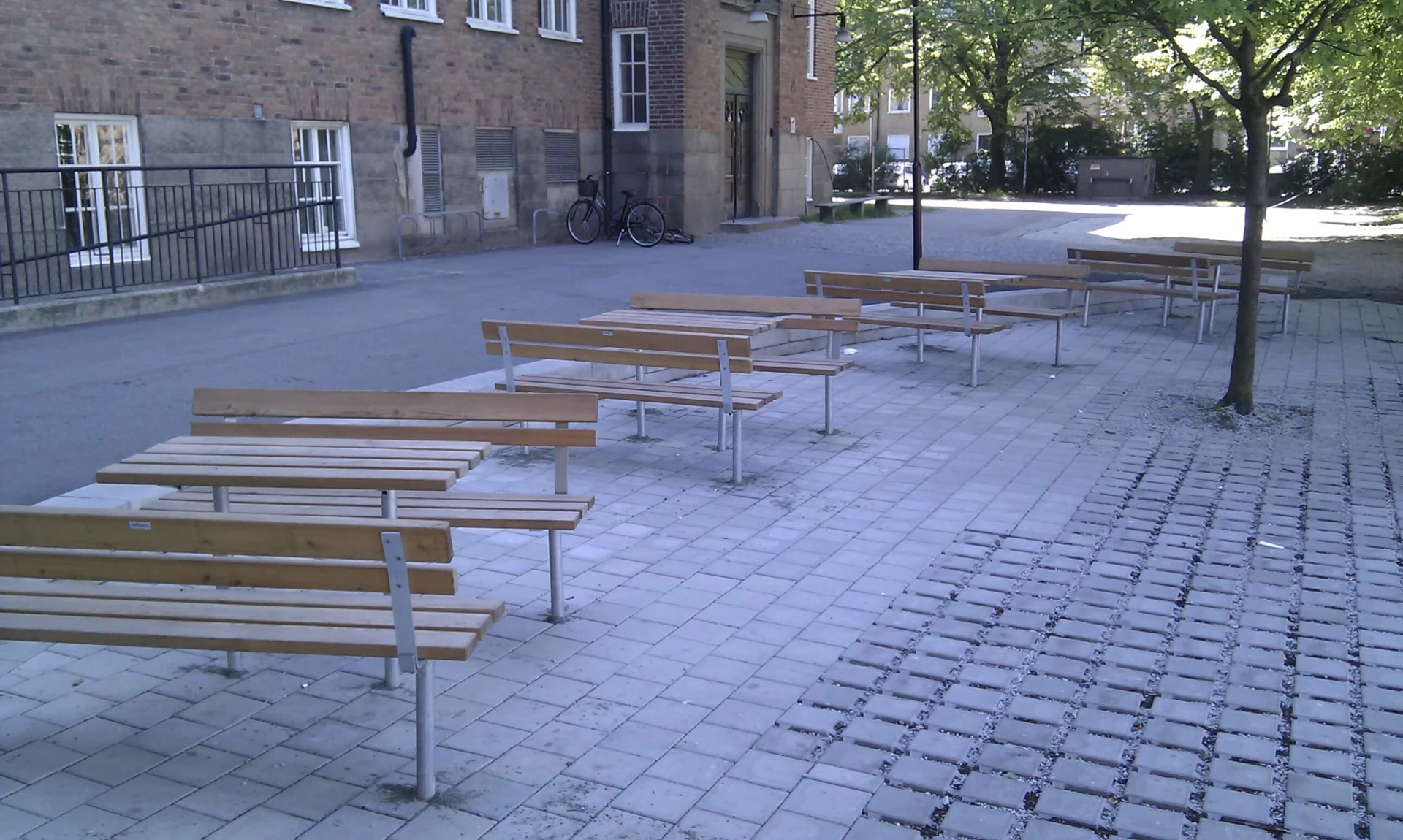 A row of park benches and tables