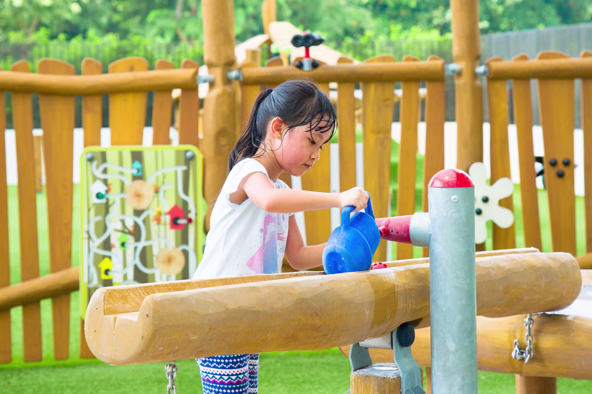 Children playing on kindergarten playground equipment in wood