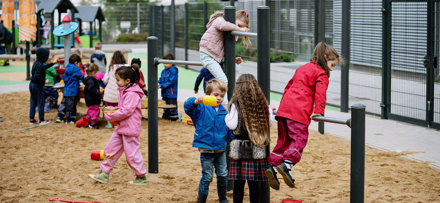 Kindergarten children playing outside on playground in germany