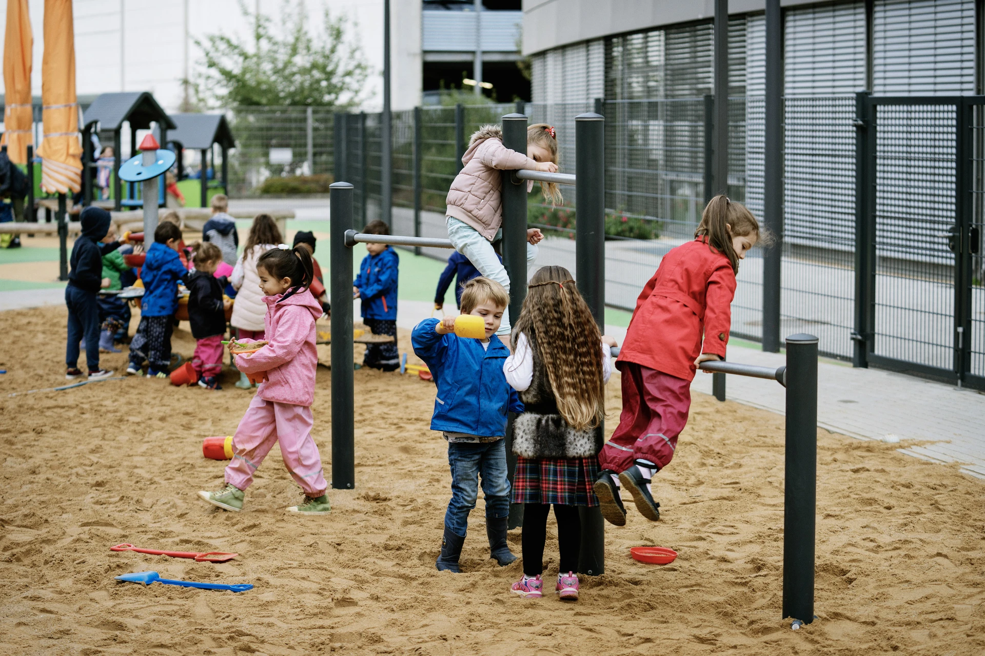 Kindergarten children playing outside on playground in germany