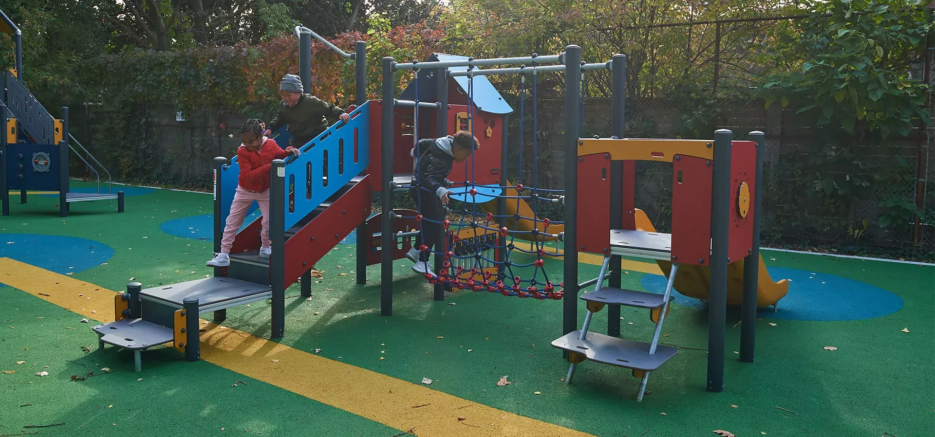 children in a park playing on MOMENTS play system for kindergartens