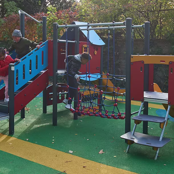 children in a park playing on MOMENTS play system for kindergartens