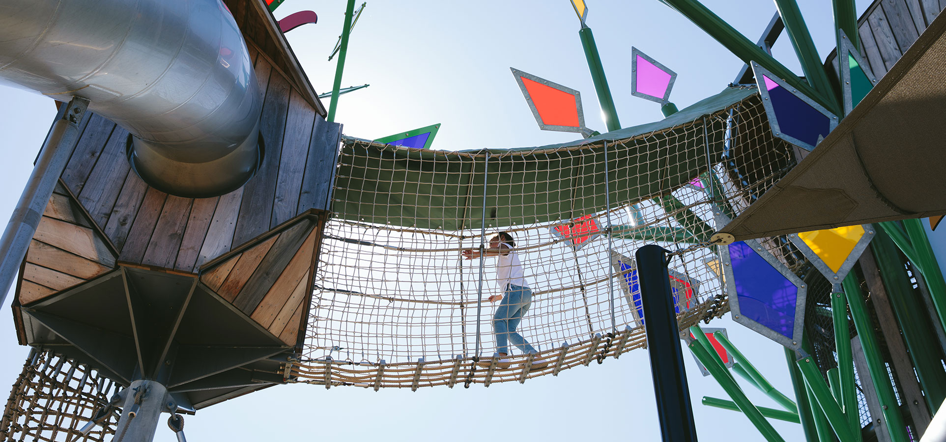 child walking on a playground sky bridge in Bells Creek