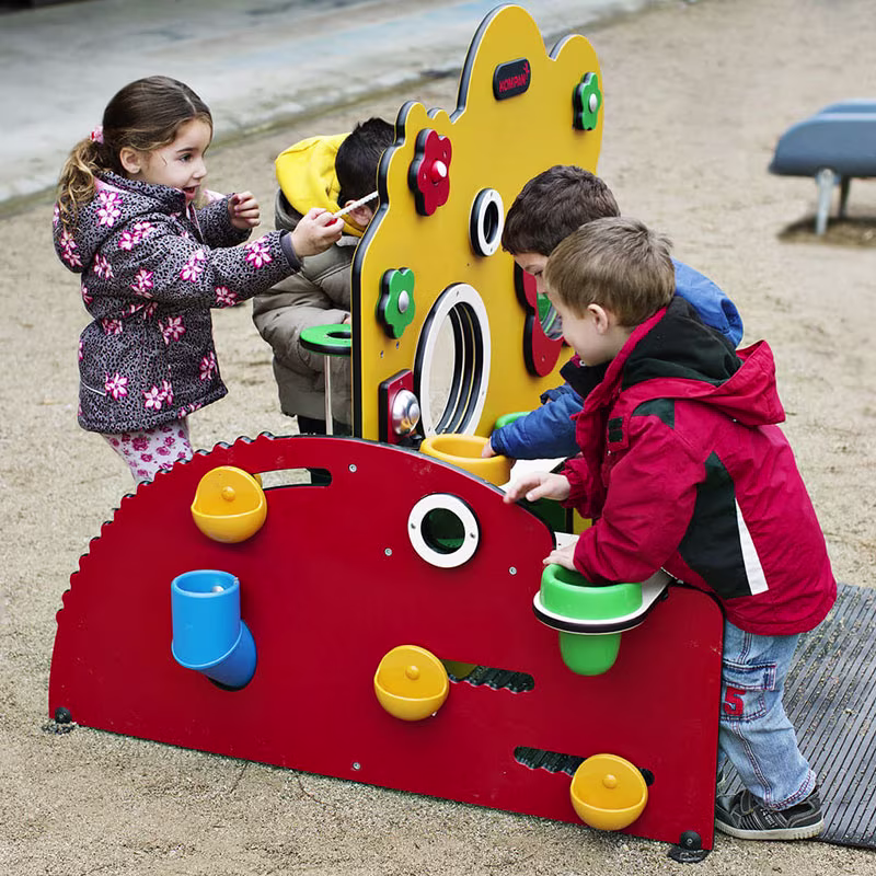 children playing in a kindergarten on a toddler station mimicking a greenhouse 