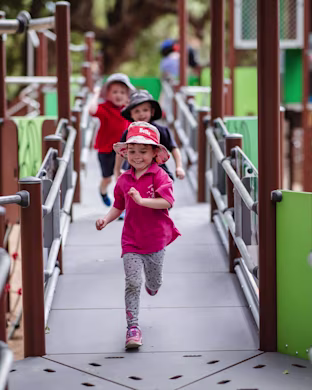 Children running on a bridge - zoo playground