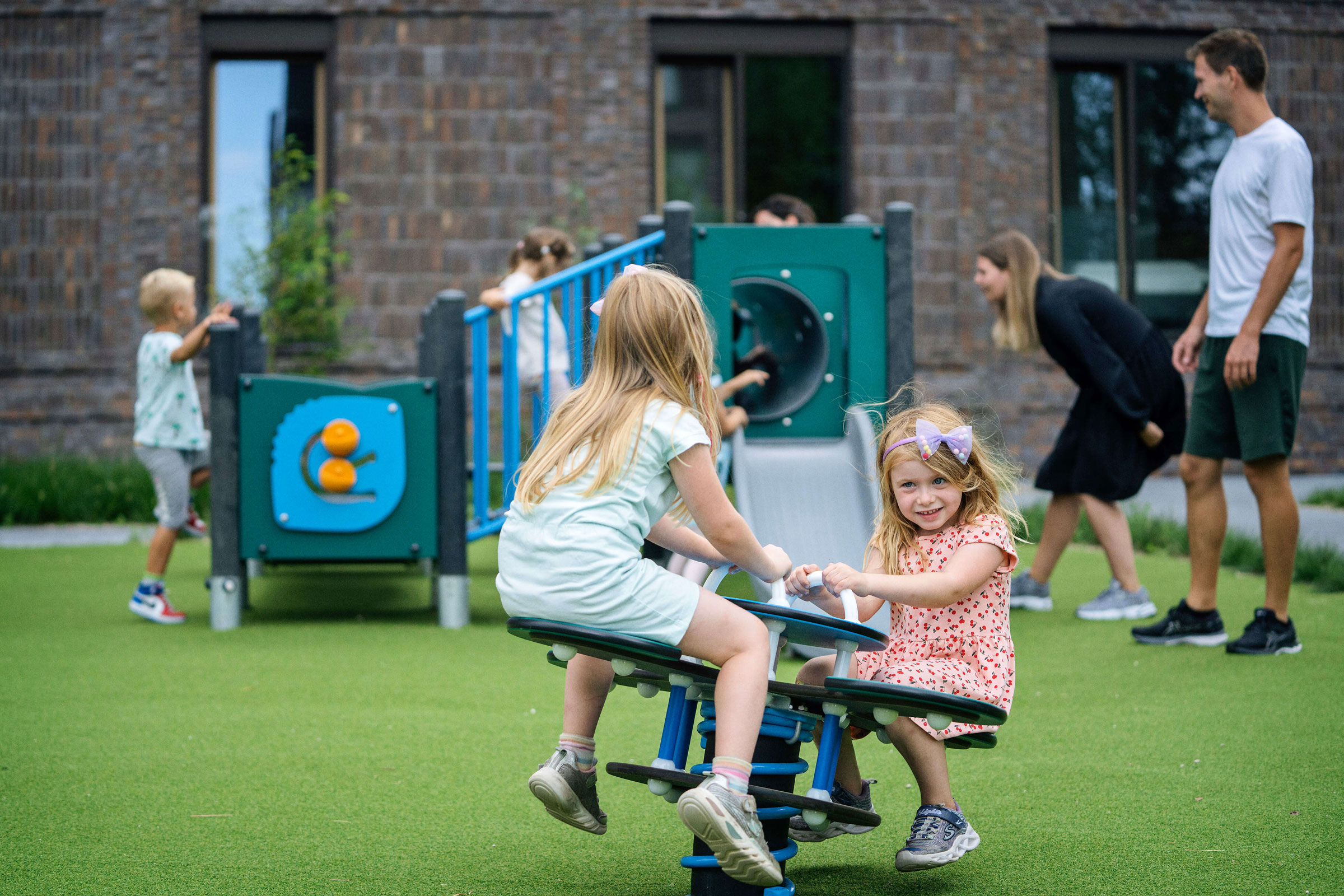 girls in primary schools playing on seesaw playground equipment