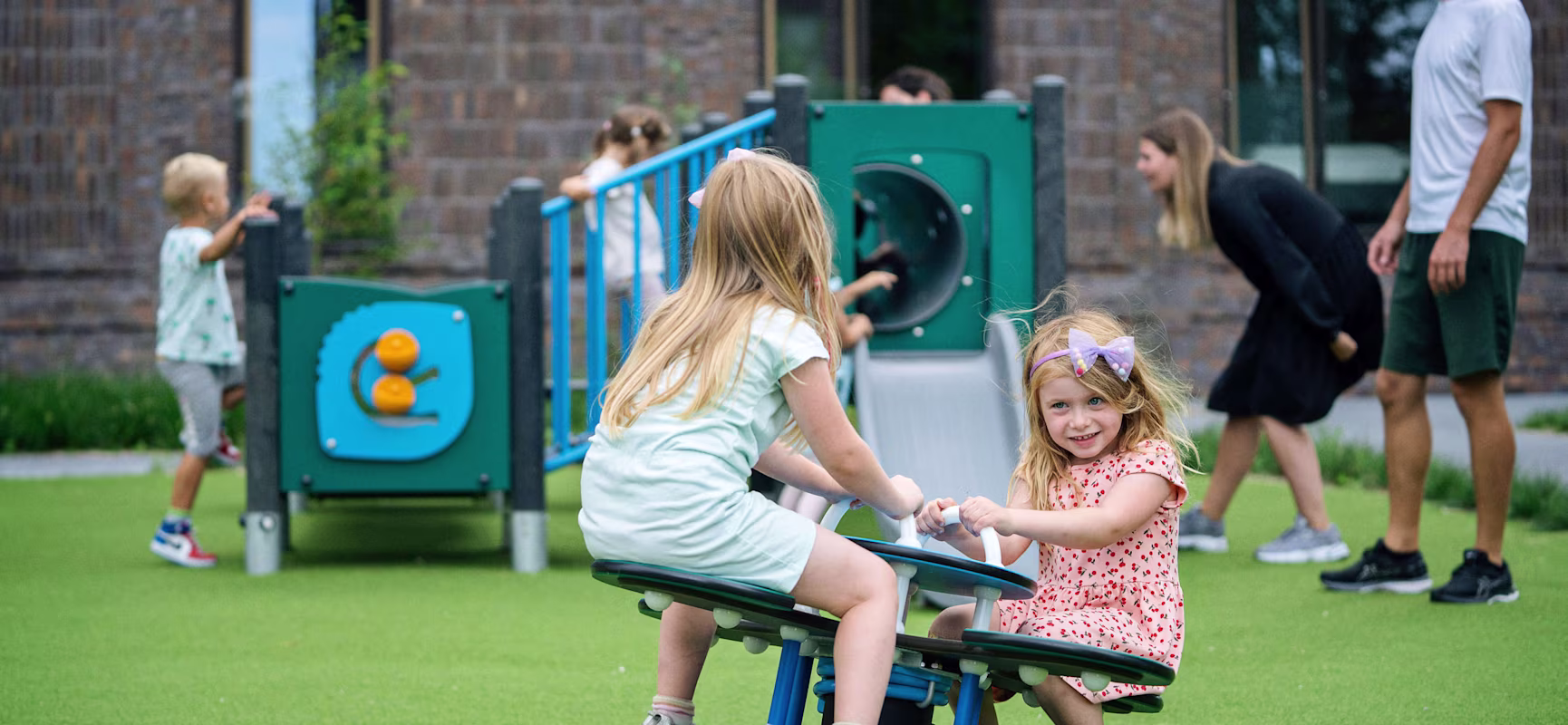 girls in primary schools playing on seesaw playground equipment