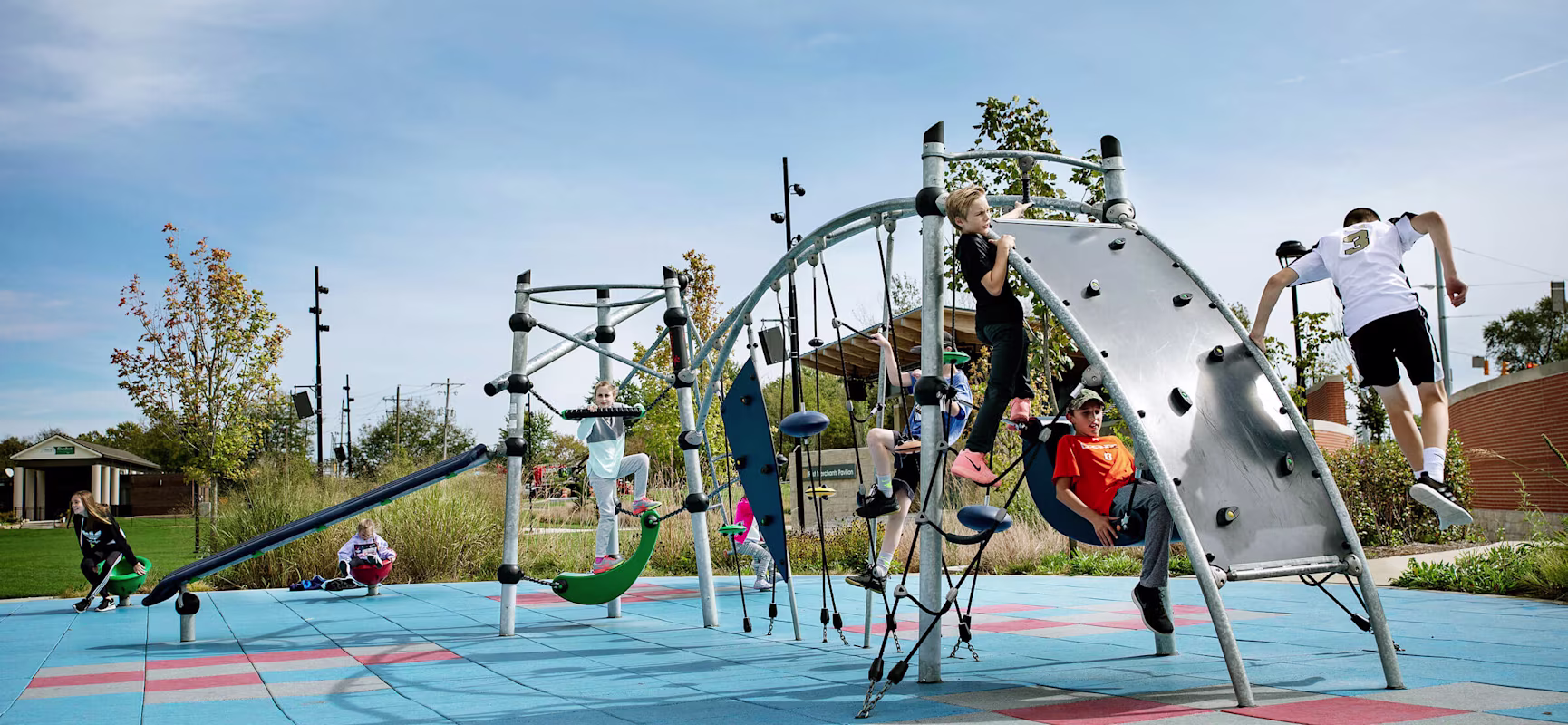 Teens playing on play system for school-agers at Federal Hill Commons Park