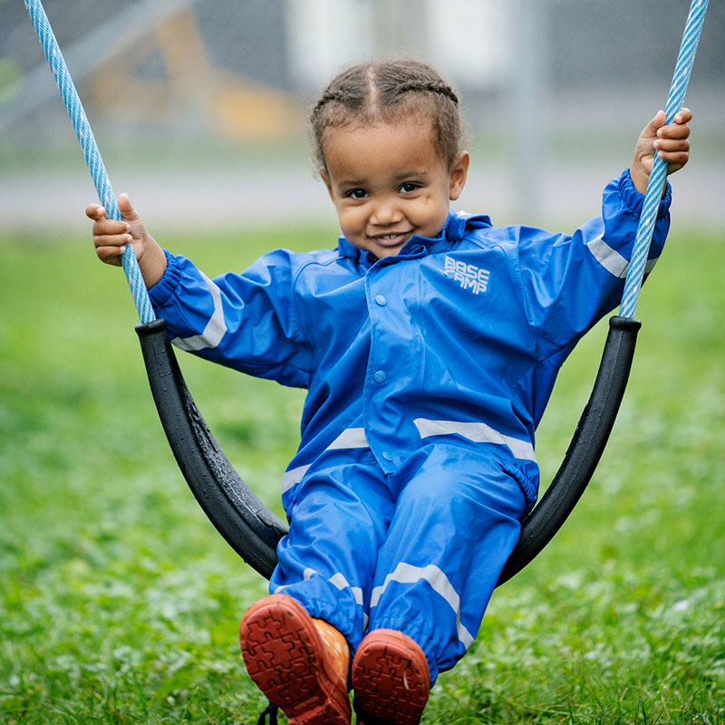 toddler swinging on playground swing for toddlers