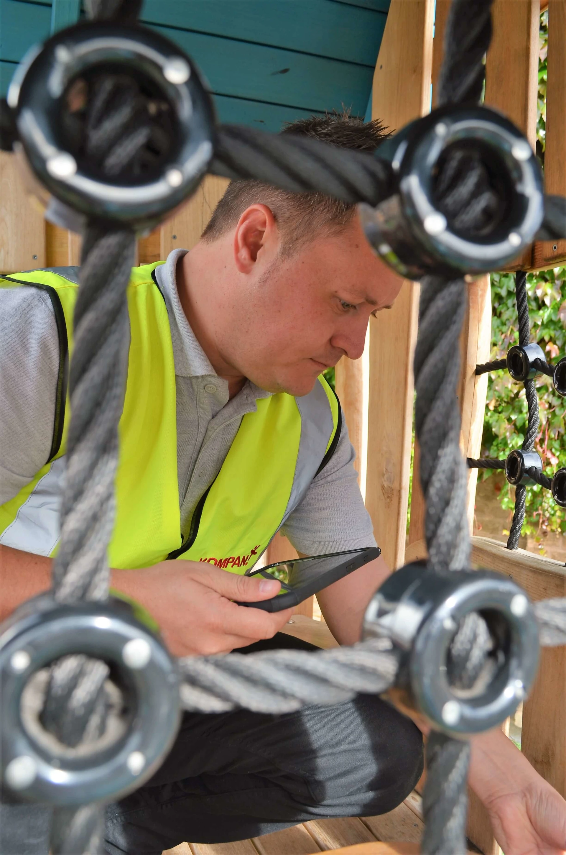 A man in a yellow vest looking at a maintanance issue