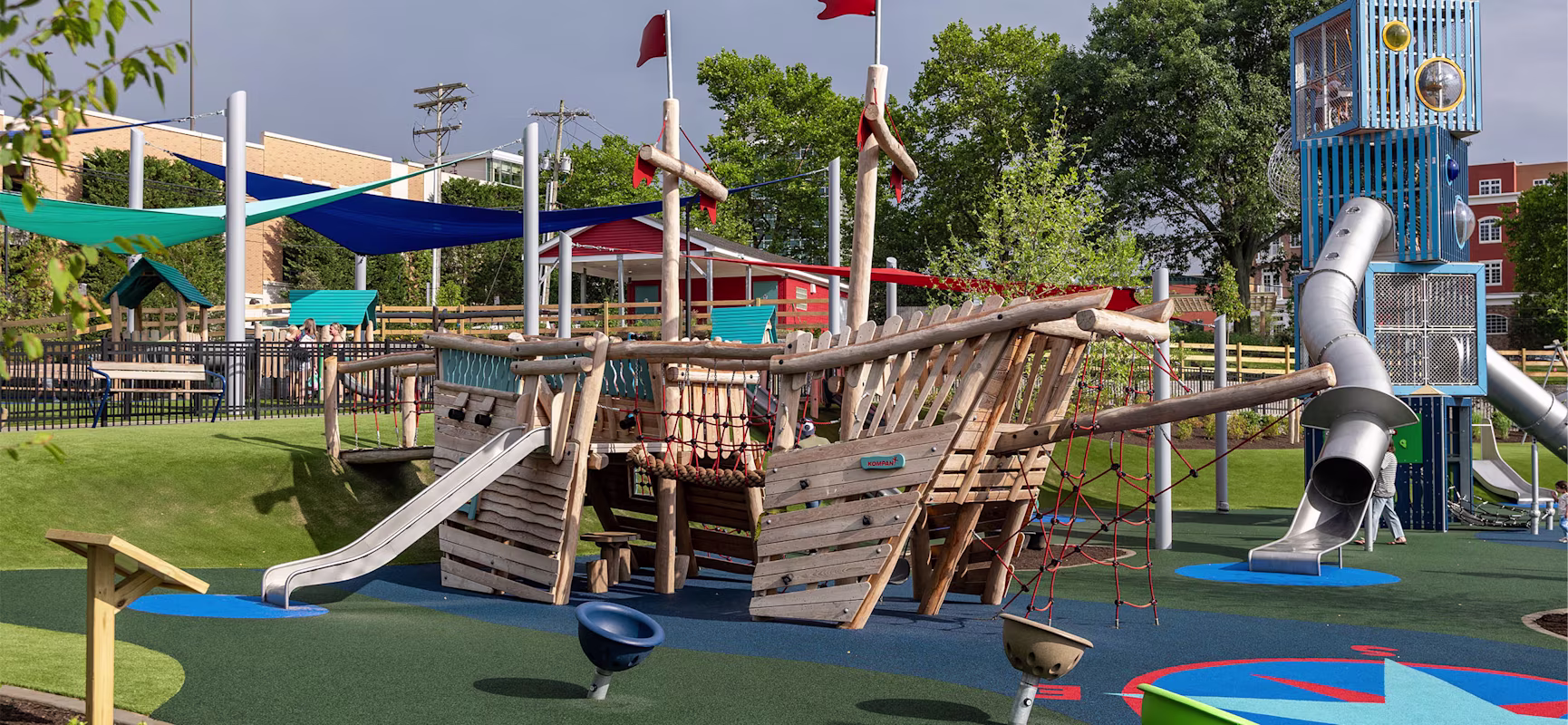 Colorful outdoor playground with KOMPAN Explorer Ship and KOMPAN Quad Cube Tower.