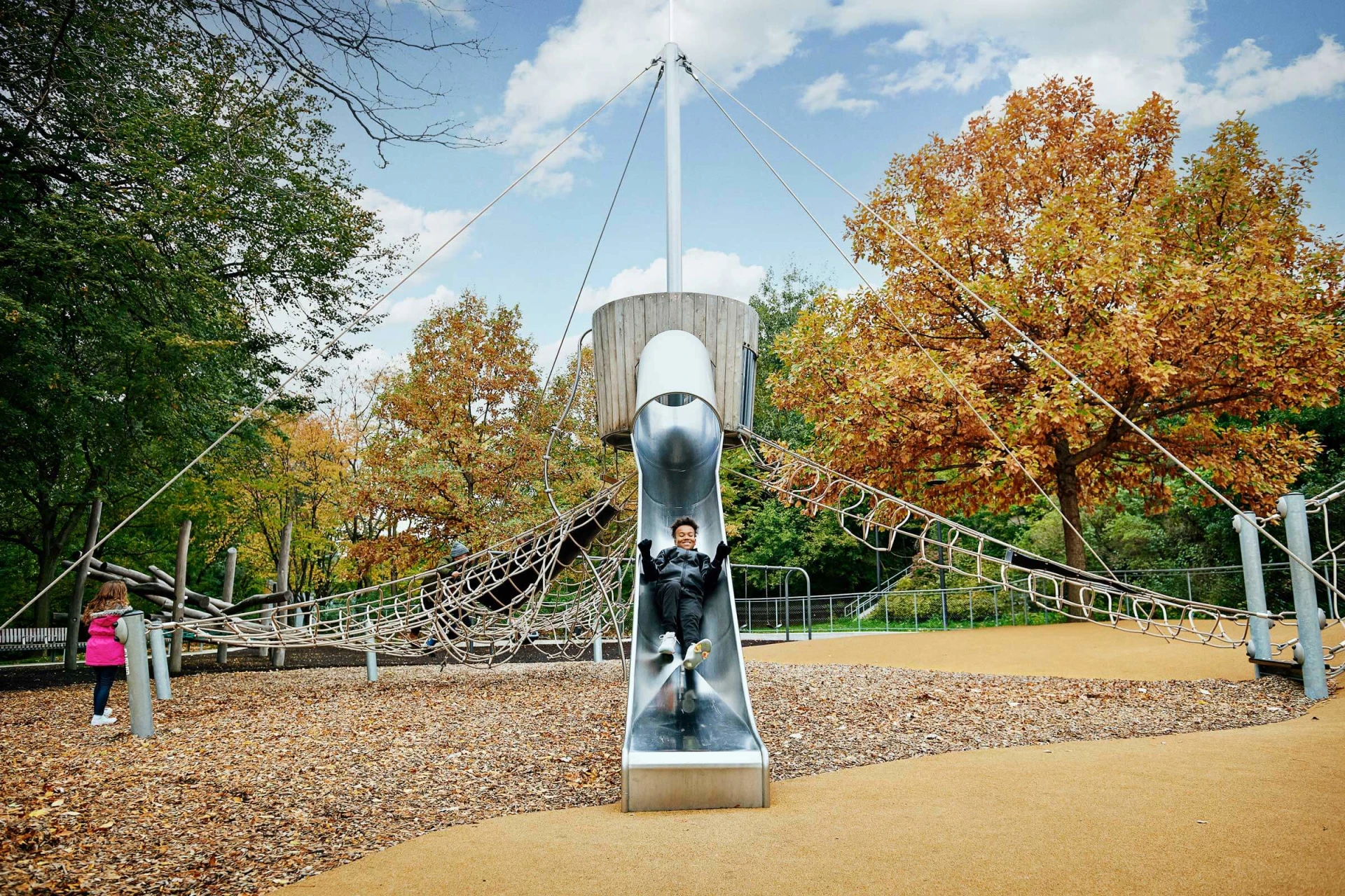 Children climbing and sliding on play tower at Ramsden Park 