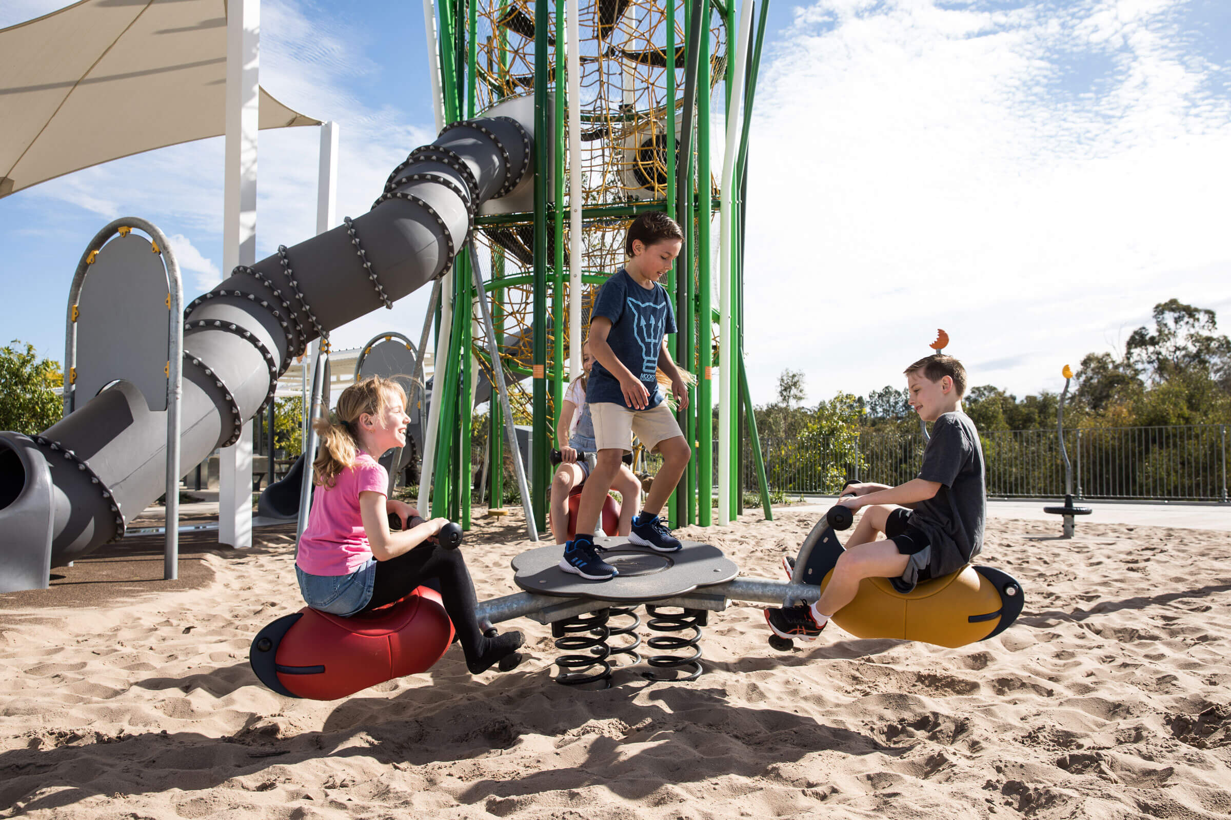 Thee children playing on a seesaw at Buxton Park