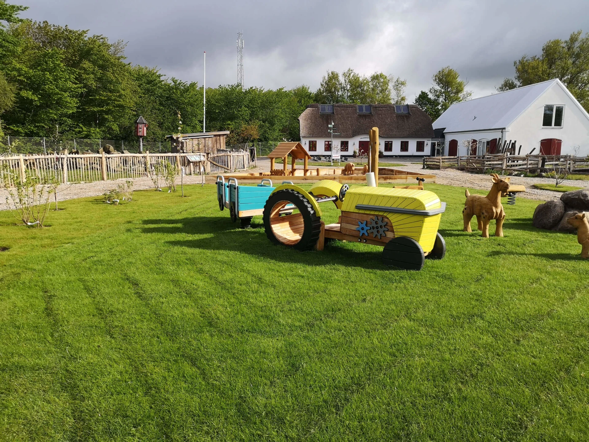 Small themed playground with wooden tractor and animals