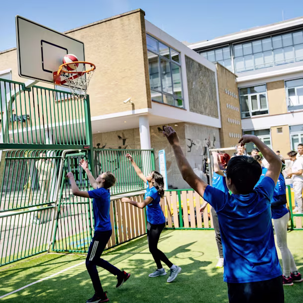 children playing football on a multisport arenas hero image