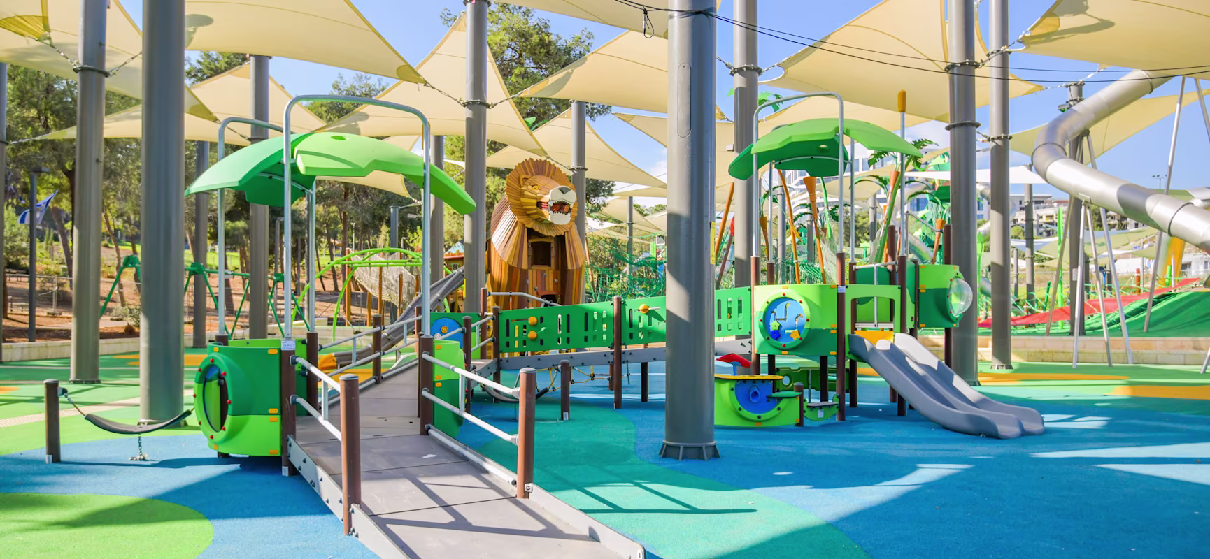 hero image of a girl sliding on a playground slide in a park