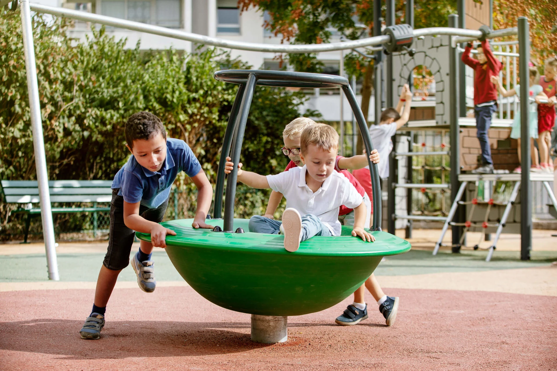children playing on classic playground equipment carousel spinner