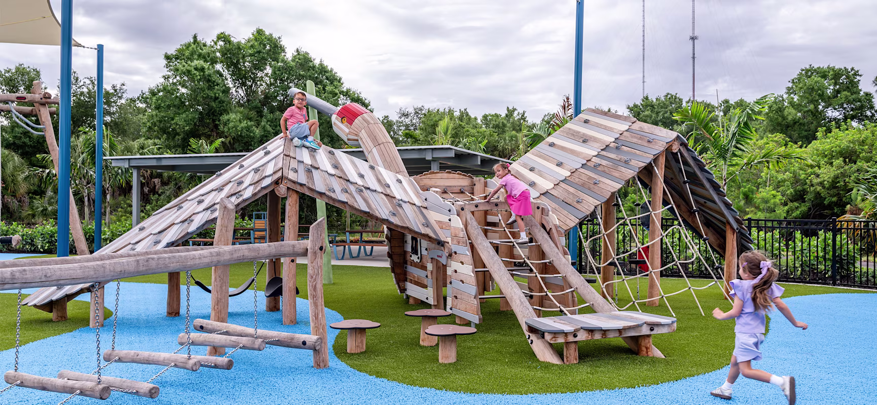 Children playing on Robinia Crane play structure at Northeast Park.