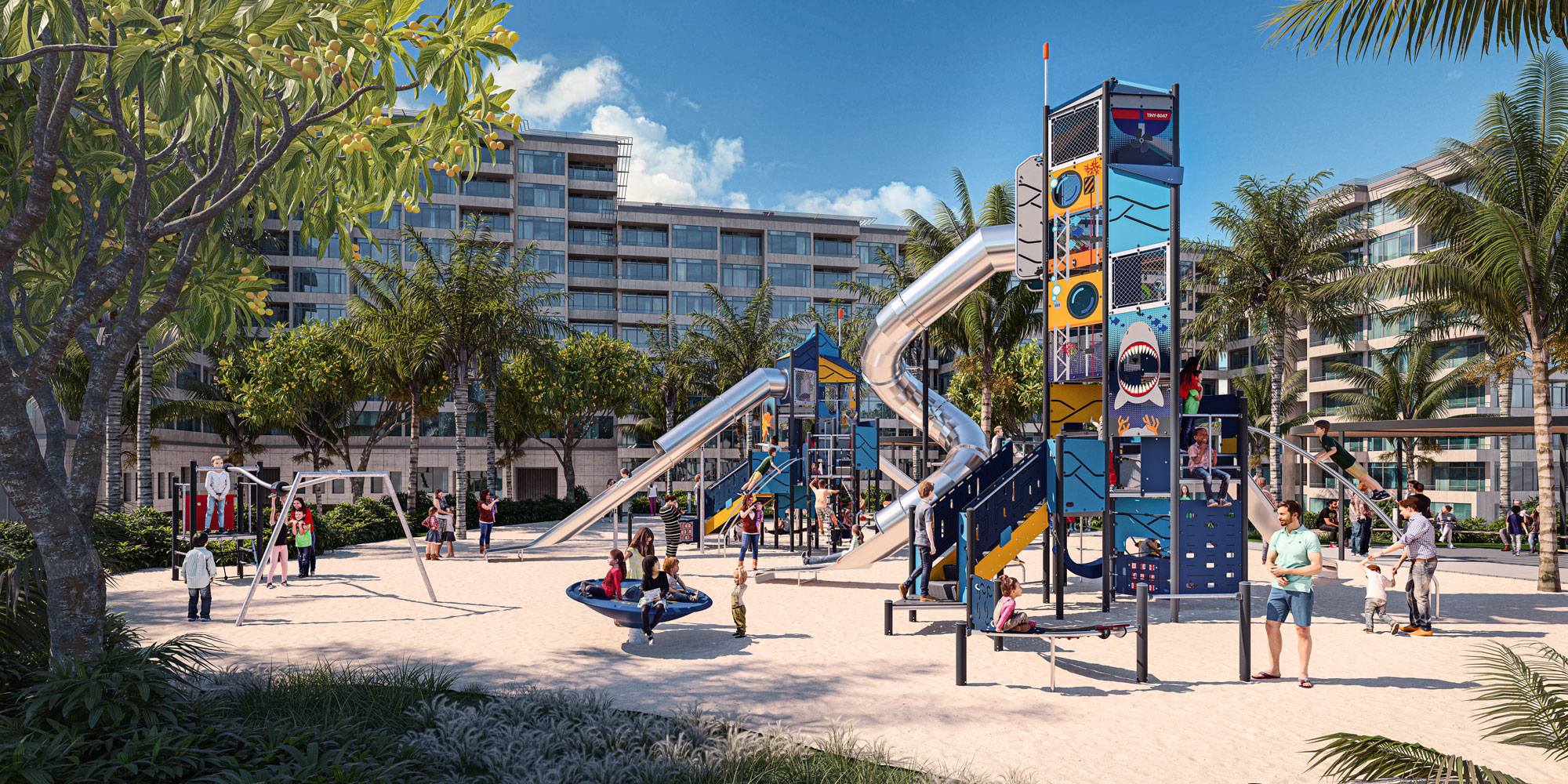 Children and adults play on colourful slides and climbing structures in a sunny sandy playground, with palm trees and apartments behind.