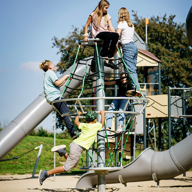 children climbing a corocord dynamics playground reference image