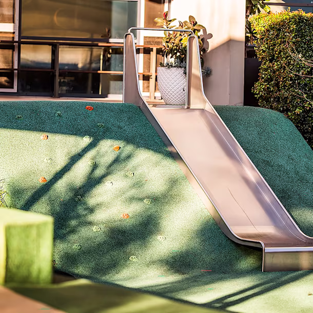 Embankment playground slide, mounted down a mound