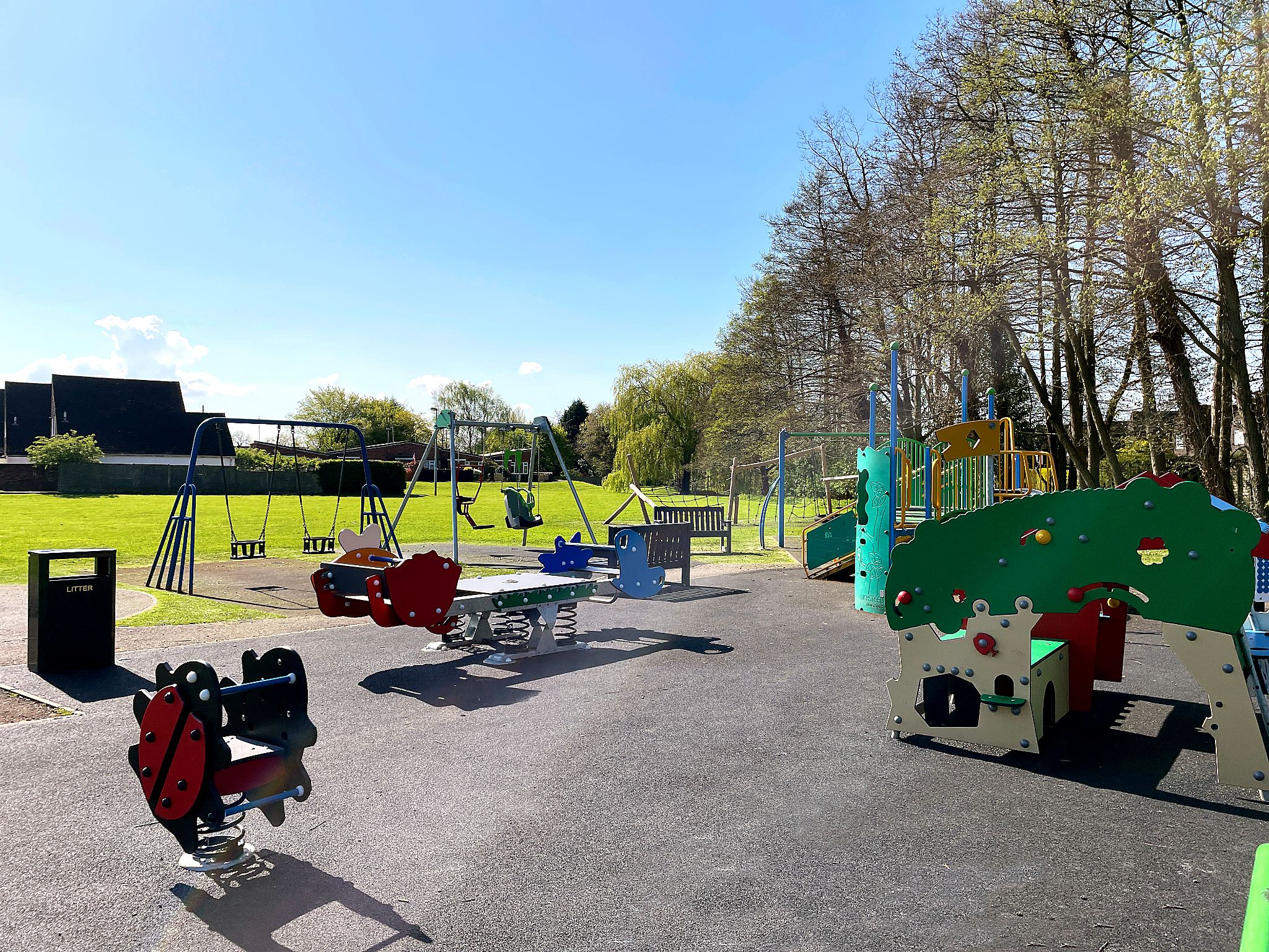 Colourful playground with ladybird springer and playhouse