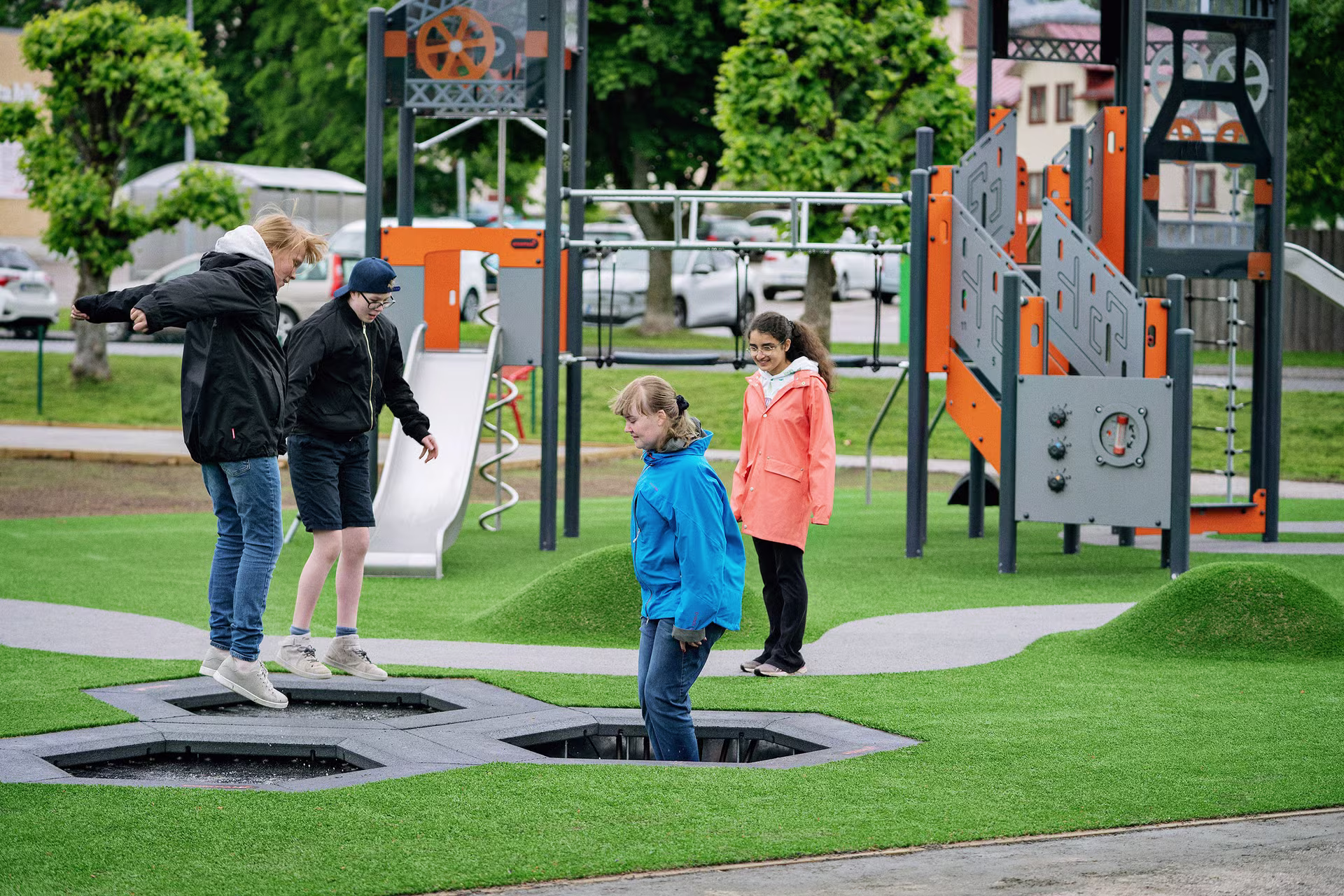 girls jumping on jumpers on a playground