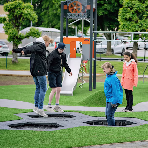 girls jumping on jumpers on a playground