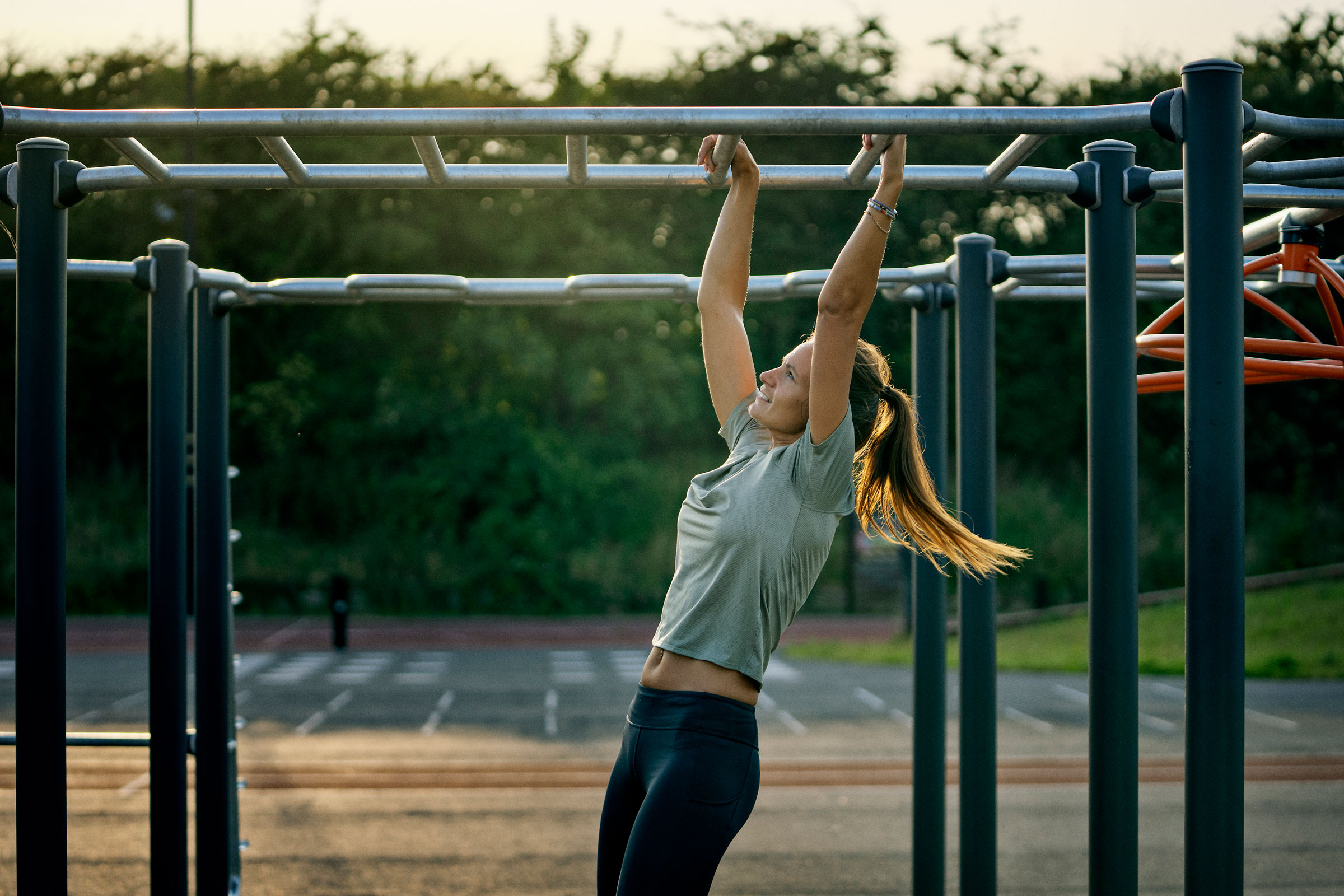 women working out on outdoor street workout station