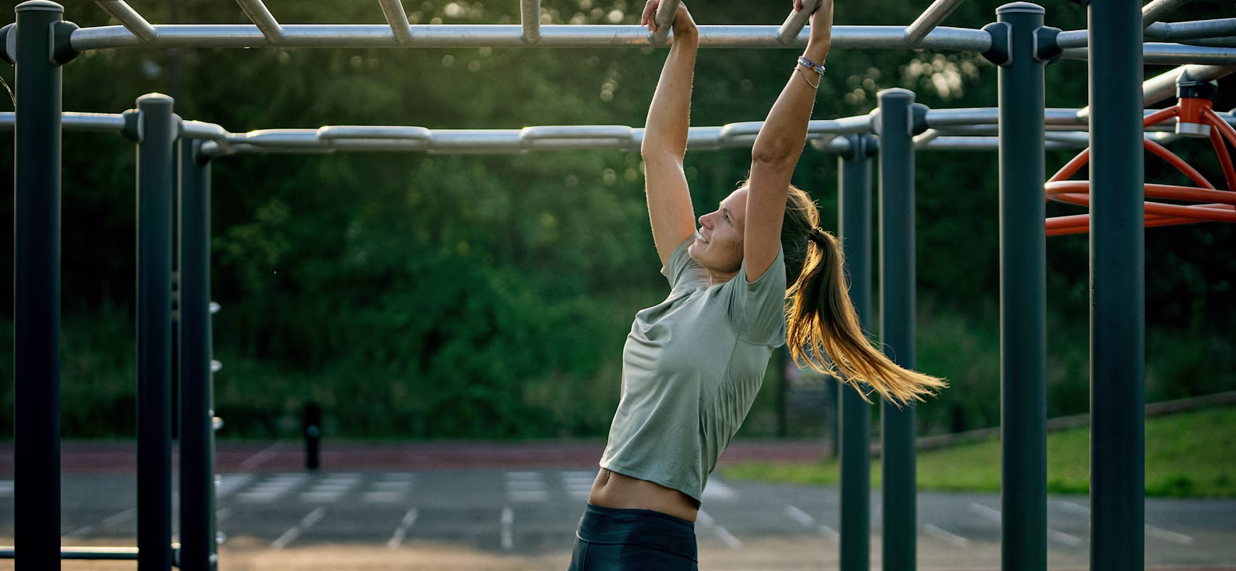 women working out on outdoor street workout station