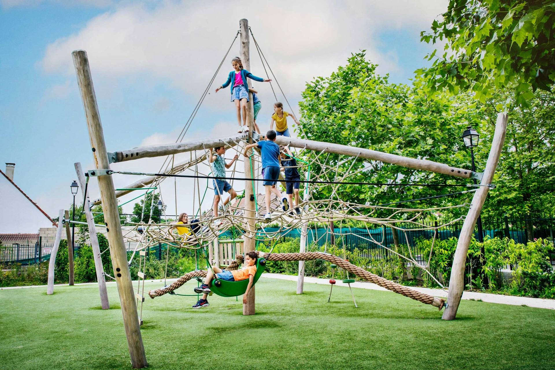 Kids playing on a natural wooden climbing structure