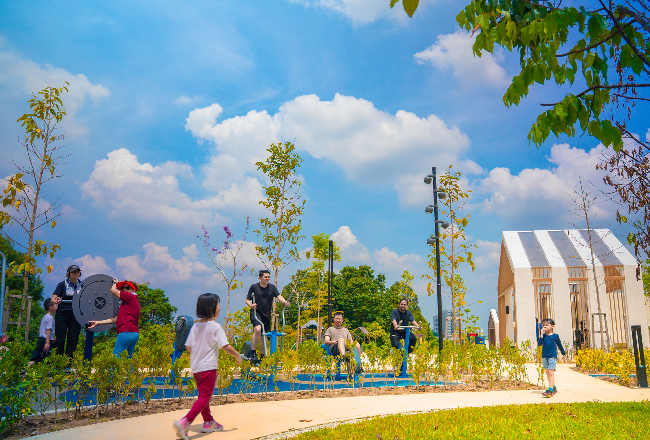 multigenerational space with children playing and adults working out.