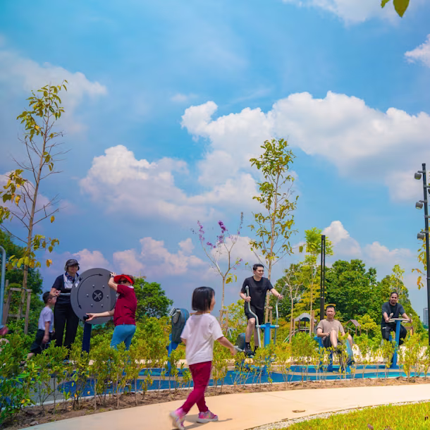 multigenerational space with children playing and adults working out.