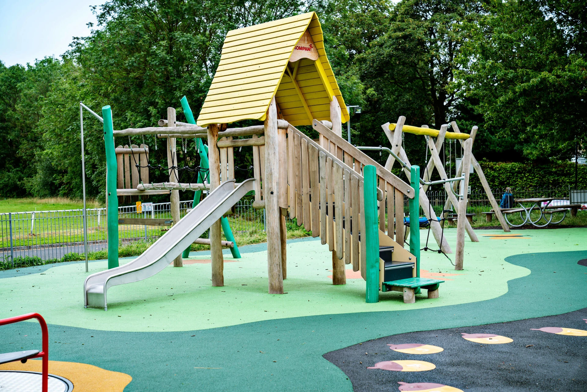 Wooden playground structure with balance bridge in Poppleton park