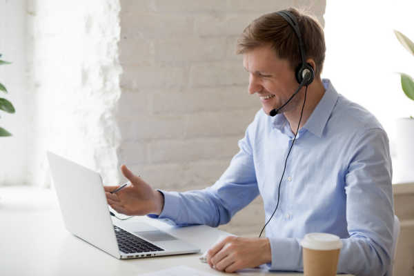 teacher-with-headphones-facing-computer