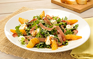 Picture of arugula salad served in a white bowl