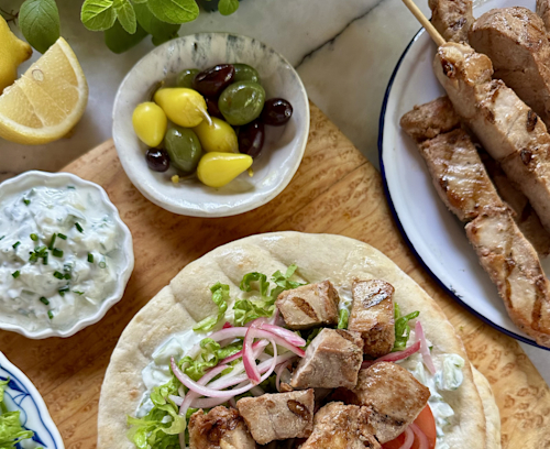Kabobs on pita with hummus and veggies