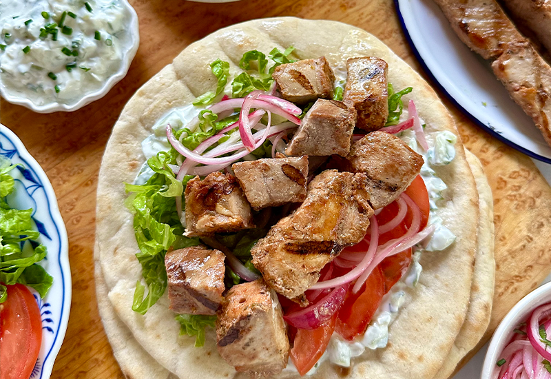 Kabobs on pita with hummus and veggies